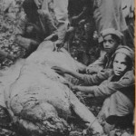 The brother of the last victim poses with the dead Chuka man eater